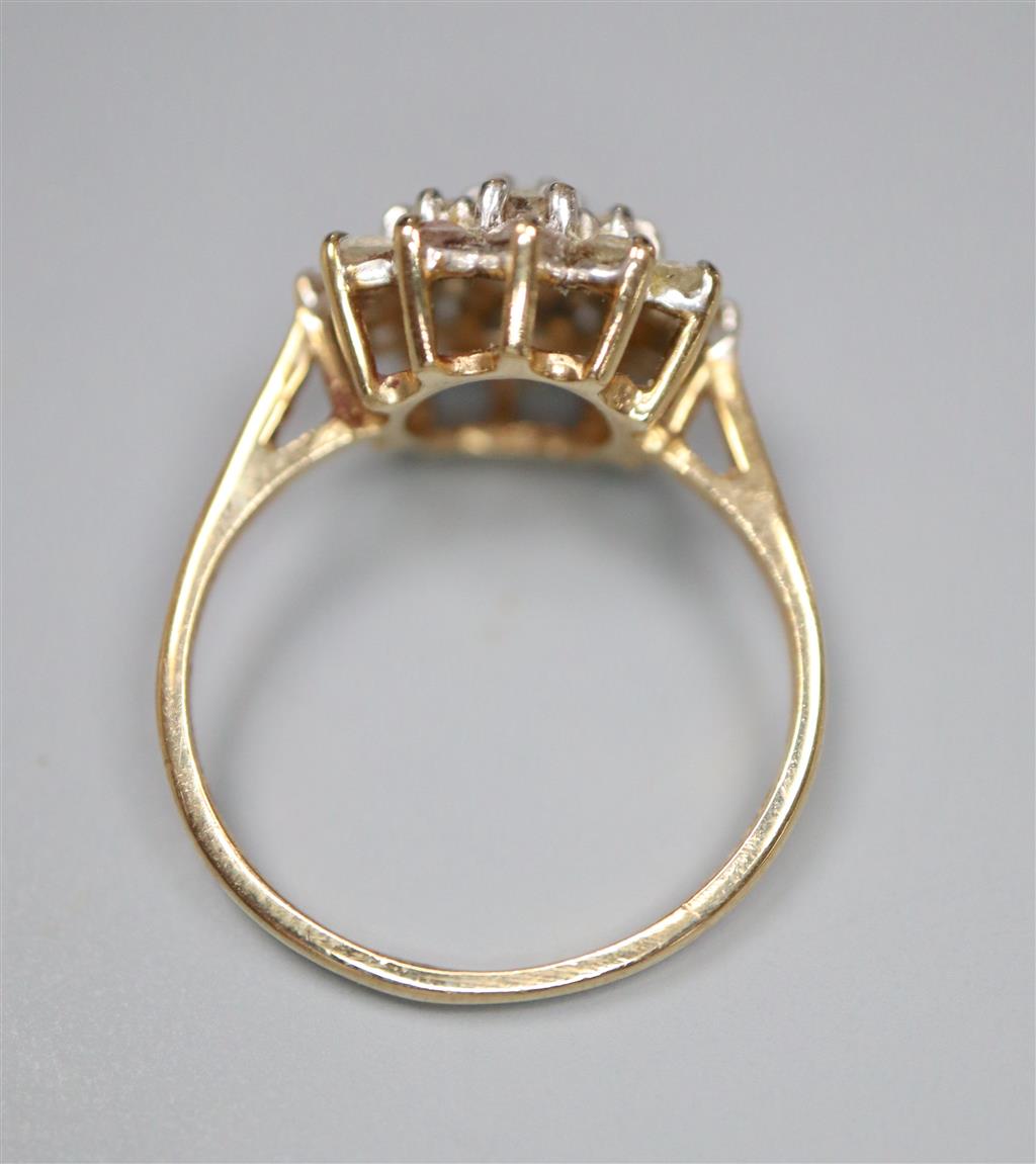 A modern 9ct gold and cubic zirconia cluster set dress ring, size J, gross 2.3 grams.